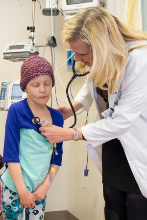 Karen Gauvain, MD, examines Madeline Thompson, 8, who has received treatment for a brain tumor. "She is as close to cancer-free as possible," said the young patient's mother, Katra Thompson.