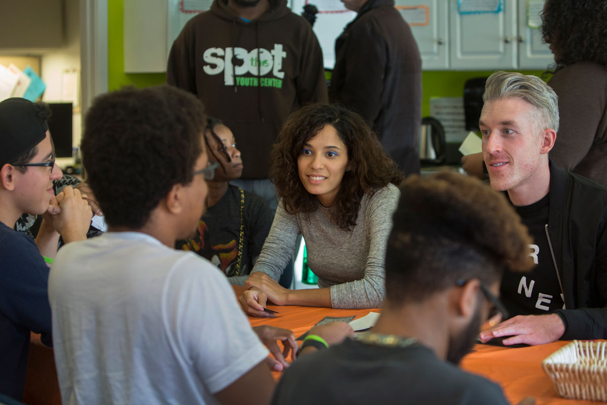 Shadille Estepan (center) and Alex Aide (right), both with Lady Gaga's Born This Way Foundation, learn about The SPOT from clients who receive services at the center.