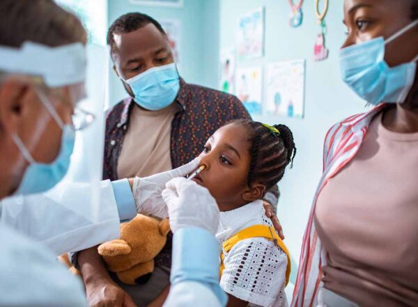 A child receives a intranasal vaccine