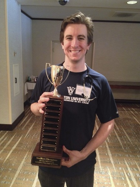 Kevin Baumgartner holds the trophy a School of Medicine team won at the Society for Academic Emergency Medicine’s Great Plains regional meeting in September 2014. The meeting included a "SimWars" competition, in which teams of medical students compete to solve simulated medical cases. Points are awarded based on speed, thoroughness, medical knowledge and communication skills. The team Baumgartner led won first place among several teams from medical schools in the region.