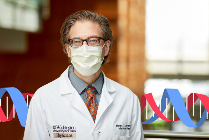 Dr. Steve Lawrence poses for a portrait wearing his white coat and a face mask