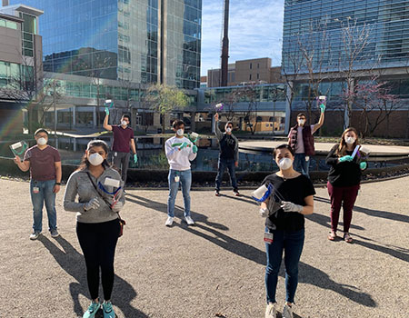 Shown with face shields they made are medical students (from left) Jesse Hu, Avira Som, Kevin Chen, Sajal Tiwary, Jerry Fong, Cathy Yu, Chase Renfroe and Katie Jordan. (Photo: Caroline Arbanas/School of Medicine)