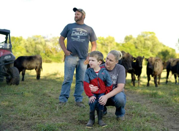 Jason and Amy Lair with their son, James, 8, on the family farm near Alexis, Ill. The Undiagnosed Diseases Network discovered a genetic variant that inhibits James’ growth.