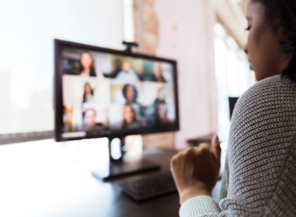 Woman video conferences with co-workers during the pandemic shutdown